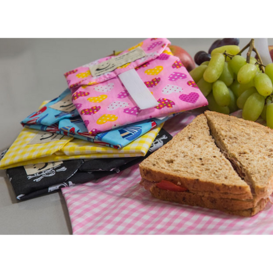 Reusable sandwich wrappers alongside sandwiches