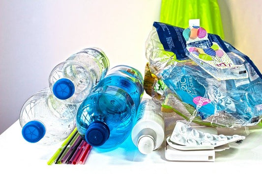 An image showing lots of plastic bottles and crisp packets