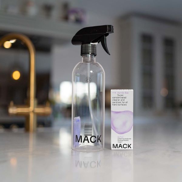 Auntie Bac super concentrated dissolvable cleaning pod in cardboard packaging shown with pod inside a spray bottle