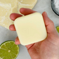 Conditioner bar for curly hair shown in the palm of a hand