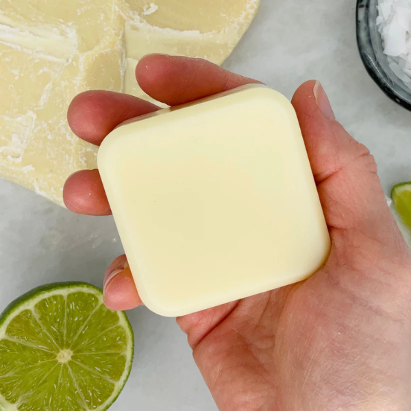 Conditioner bar for curly hair shown in the palm of a hand