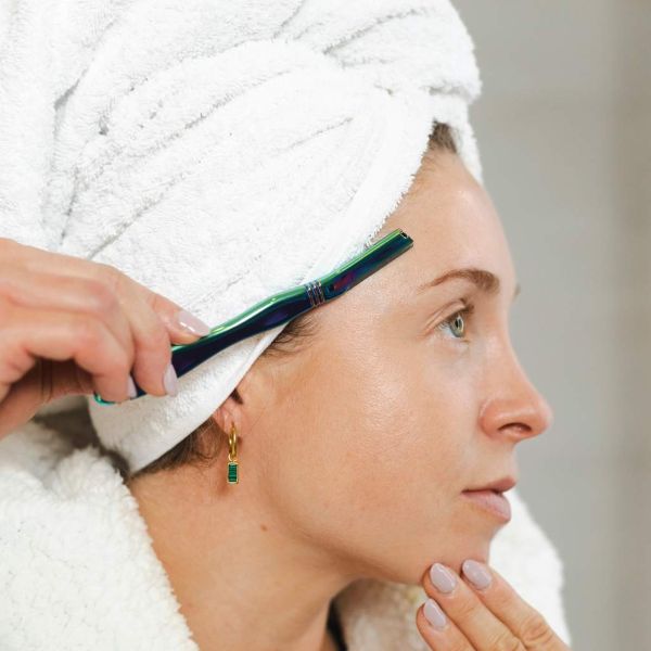 Jungle Culture's dermaplaner being used at the side of a face