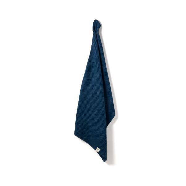 Knitted cotton hand towel in Ocean blue shown hanging up