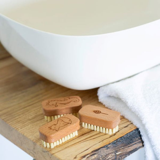 Three kids vegan wooden nail brushes at side of sink