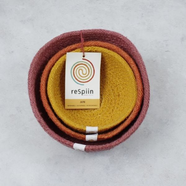 Set of three mini jute bowls in Fire colour (bright pink, orange and yellow) stacked inside each other