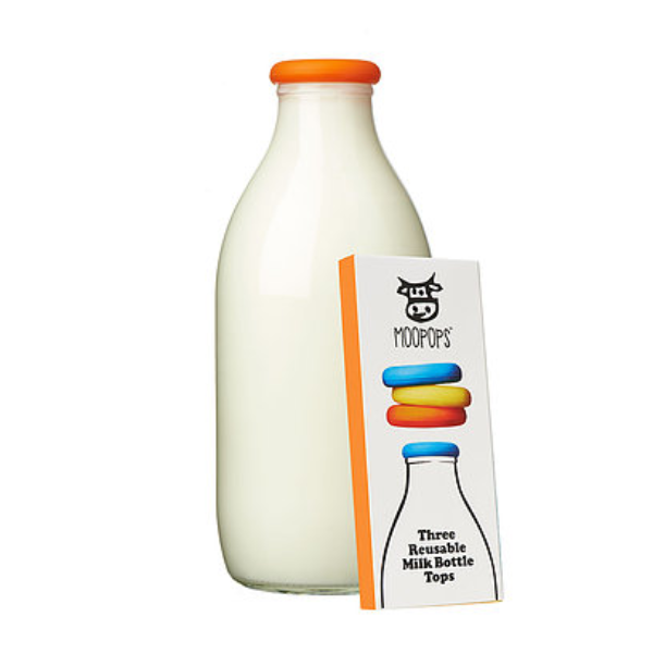 Moopops silicone bottle lid on top of a bottle next to cardboard packaging