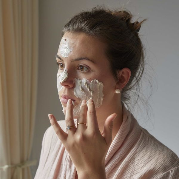 UpCircle face mask in glass jar shown being applied to a face