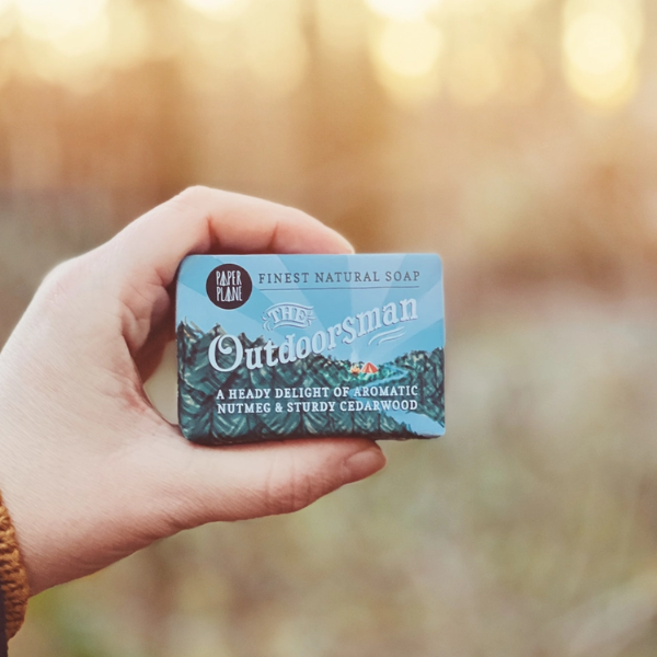 The Outdoorsman soap bar held in a hand