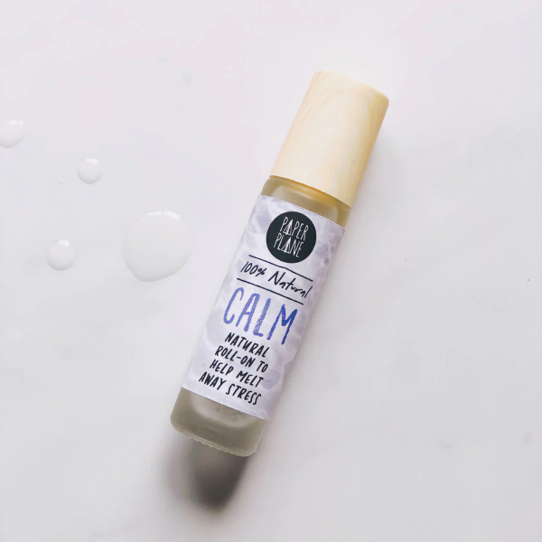 Natural pulse point roll with bamboo lid on, with text on label reading '100% natural Calm natural roll-on to help melt away stress'