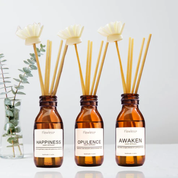 Eco reed diffuser home fragrance collection - three amber glass bottles with reeds