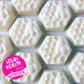 Several clarifying peppermint shampoo bars for curly hair, a hexagonal shaped bar with honeycombs and a bee shaped into the bar, with logo reading "Vegan Beauty Awards winner"