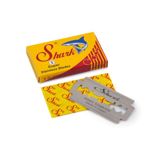 Shark razor blades showing the cardboard box packaging alongside a blade next to wax wrapping paper