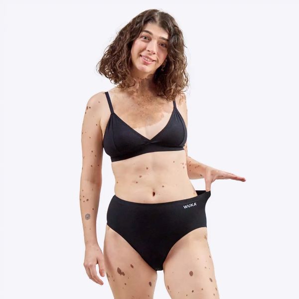 Stretch cotton period pants midi brief seamless stretch shown close up on model with thumb inserted in waistband