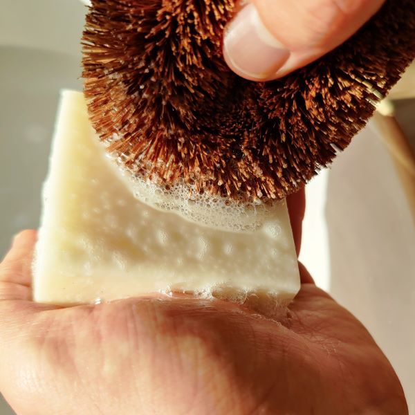 Loofco eco-friendly dishwashing soap bar in use