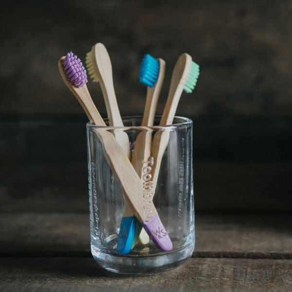 Kids bamboo toothbrush set, pack of 4 multicoloured standing in glass
