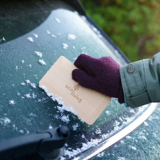 Wooden window or pastry scraper in use on car window