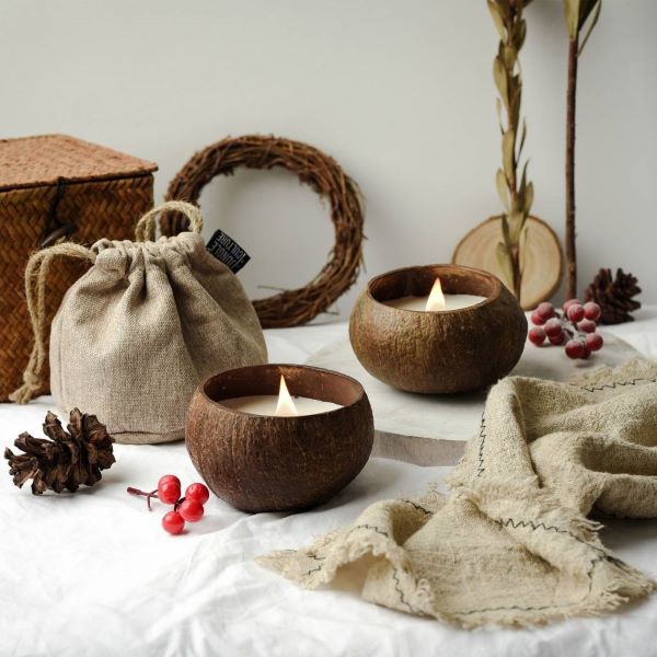 Two natural eco-friendly candles in coconut shell (lit)