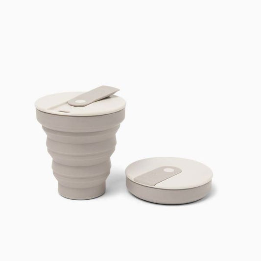 Collapsible cup shown up and collapsed in warm grey
