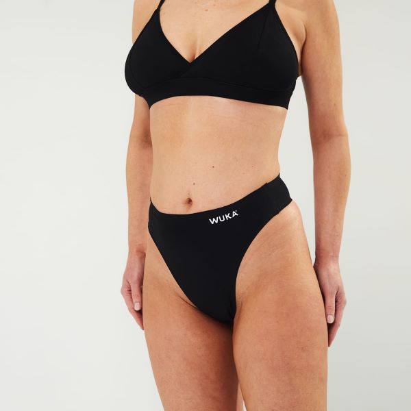 Black stretch thong period pants shown on model from front