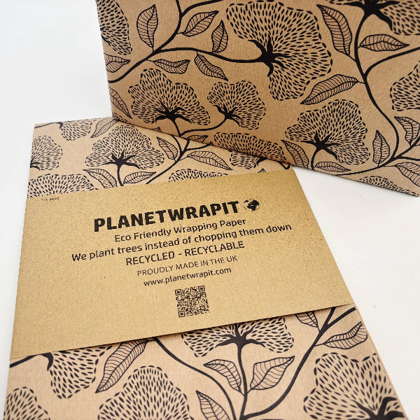Planet Wrapit eco-friendly kraft wrapping paper with black floral design and PlanetWrapIt paper label shown alongside a wrapped parcel.