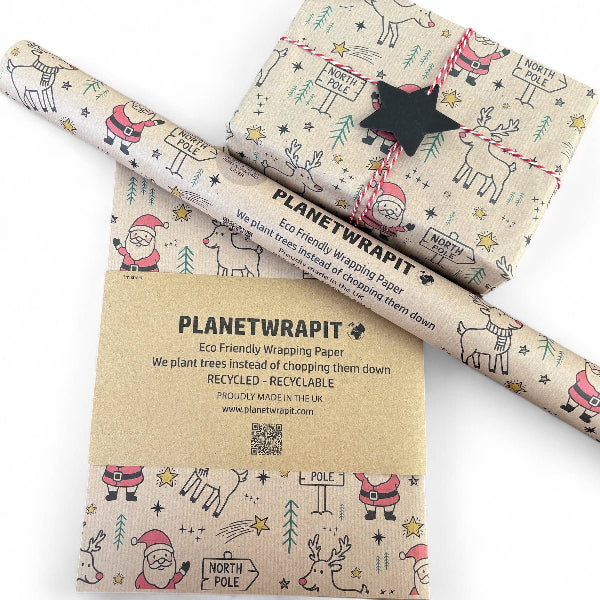 PlanetWrapIt recycled kraft wrapping paper in Christmas Santa and Rudolph (brown paper with printed Santas, Rudolphs and North Pole signs) with PlanetWrapIt paper label alongside wrapped parcel