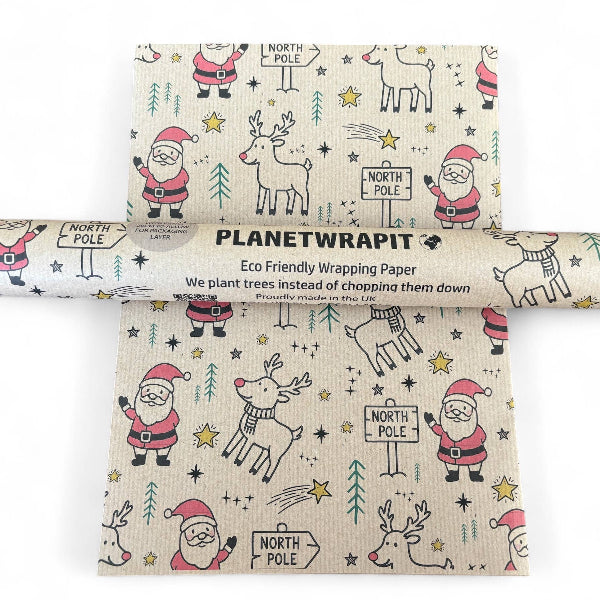 PlanetWrapIt recycled kraft wrapping paper in Christmas Santa and Rudolph (brown paper with printed Santas, Rudolphs and North Pole signs) alongside PlanetWrapIt paper roll