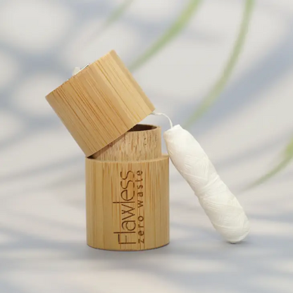 Bamboo floss container with floss alongside