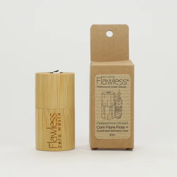 Bamboo floss container alongside its cardboard packaging