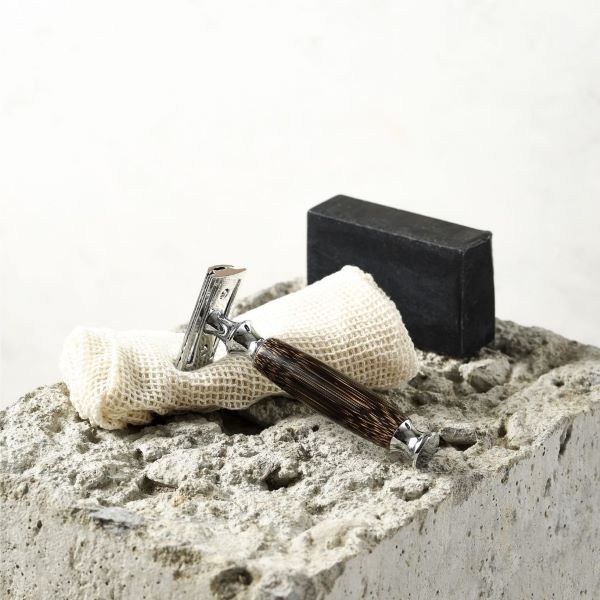Bamboo safety razor with dark wood thick handle shown with a cloth and soap bar