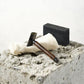 Bamboo safety razor with dark wood thin handle shown balanced with cloth and soap bar
