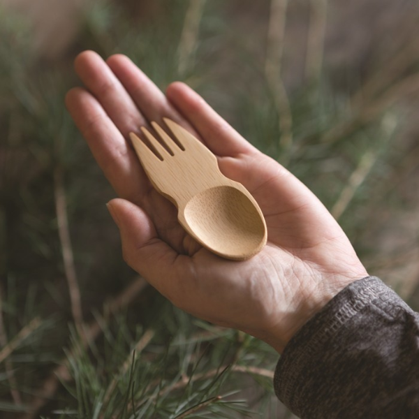 Bamboo spork shown in the palm of a hand