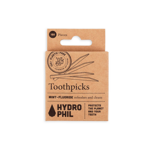 Bamboo toothpicks shown in cardboard packaging with text reading 'Toothpicks mint-fluoride, refreshes and cleans'