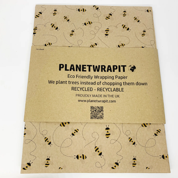 Eco-friendly recyclable wrapping paper in bees design (brown paper with little bees flying around) shown as single sheet