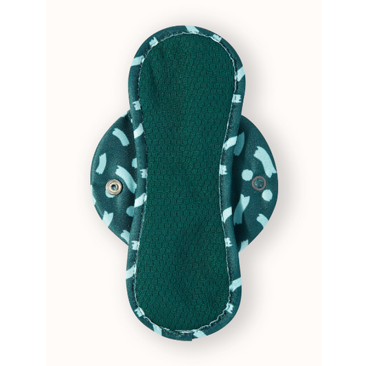 Reusable period pad in Celeste design (teal background with light blue pattern), liner shown from above