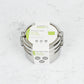 Stainless steel stackable round lunch boxes with paper wrapping on a white surface.