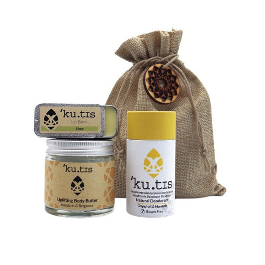 Eco-friendly natural skincare gift pouch shown with the products alongside - a natural deodorant in paper tube, lip balm in metal tin and uplifting body butter in glass jar (citrus fragrances)