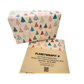 Parcel wrapped in recycled handmade wrapping paper in Colourful Christmas Trees design (brown kraft background with colourful Christmas trees in a hand-drawn style) shown on a wrapped parcel next to the paper with paper wrapper