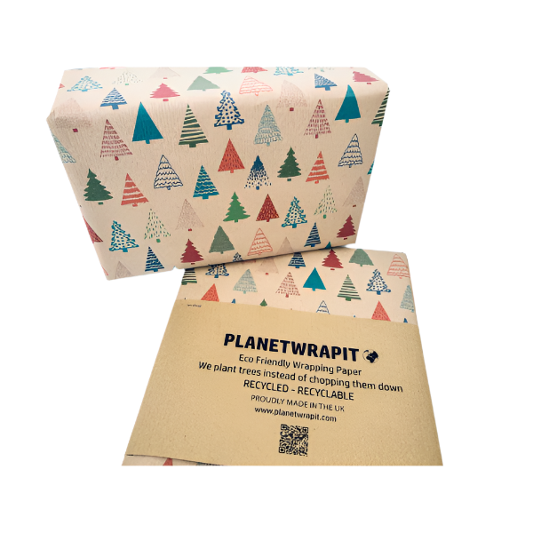 Parcel wrapped in recycled handmade wrapping paper in Colourful Christmas Trees design (brown kraft background with colourful Christmas trees in a hand-drawn style) shown on a wrapped parcel next to the paper with paper wrapper