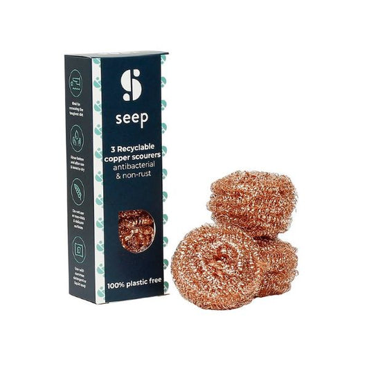 Set of three eco-friendly copper scourers alongside the cardboard packaging