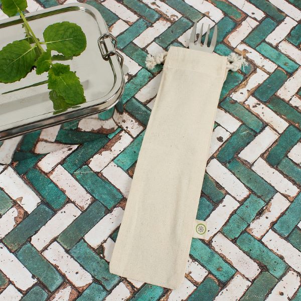 Organic cotton utensil bag shown with a steel spork peeking out on a tiled surface with a metal sandwich box