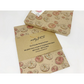 Eco-friendly recyclable wrapping paper in doughnuts design (brown paper with pink and white sprinkled doughnuts) shown alongside a wrapped box