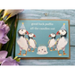 Eco birthday card, blue background with 4 puffins with party hats and a birthday cake with the words "good luck puffin all the candles out" 