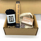 Eco-friendly starter gift set inside cardboard packaging with contents inside in shades of black and brown