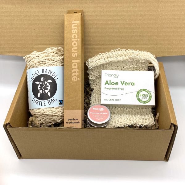 Eco-friendly starter gift set inside cardboard packaging with contents inside in natural shades