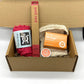 Eco-friendly starter gift set inside cardboard packaging with contents inside in bright shades of red and orange