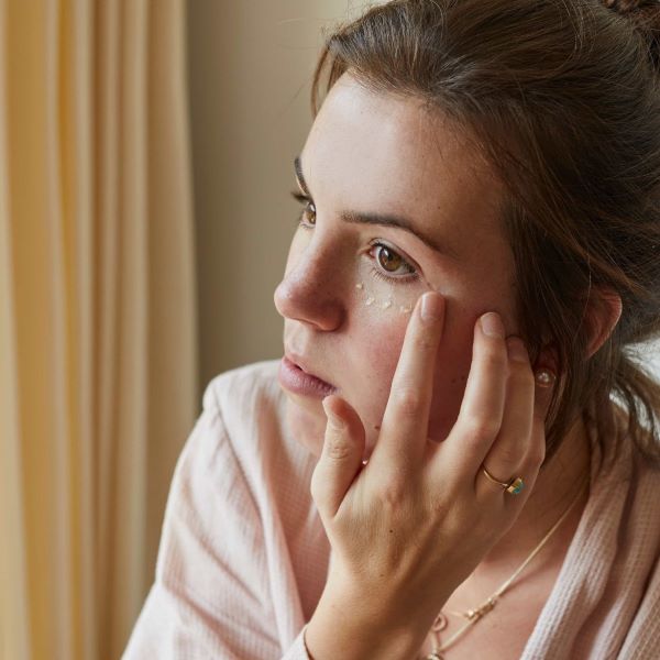 UpCircle eye cream being applied to the face