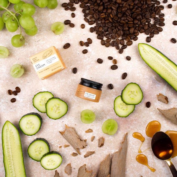 UpCircle eye cream shown surrounded by coffee beans and cucumbers