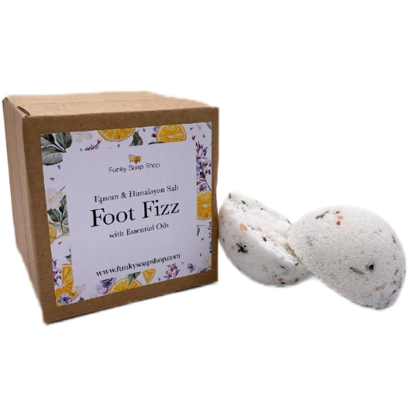 Foot fizz shown in two halves alongside cardboard box packaging reading "Epsom and Himalayan salt foot fizz with essential oils"