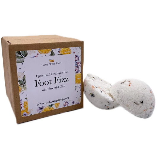 Foot fizz shown in two halves alongside cardboard box packaging reading "Epsom and Himalayan salt foot fizz with essential oils"