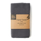 Knitted cotton hand towel in Slate grey shown in kraft paper packaging